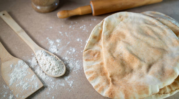 istock Kuboos or khubz - Arabic bread on a brown table in the kitchen 1268028674