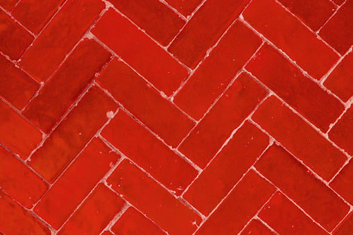 Shot of seamless texture retro red herringbone brick flooring tiles