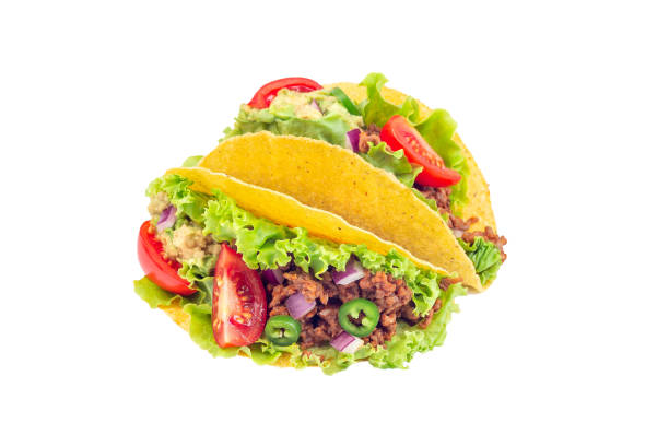 istock Two taco shells with lettuce, ground beef meat,  mashed avocado, tomato, red onion and jalapeno pepper, isolated on white, closeup 1268032778