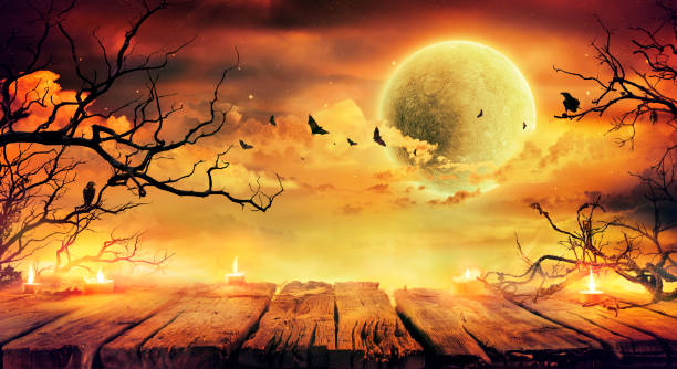 オレンジのハロウィーン - ��満月と怖い夜にろうそくと枝と古いテーブル - wooden bat ストックフォトと画像