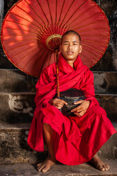 istock Young Buddhist monk standing next to temple, Bagan, Myanmar 1268040854