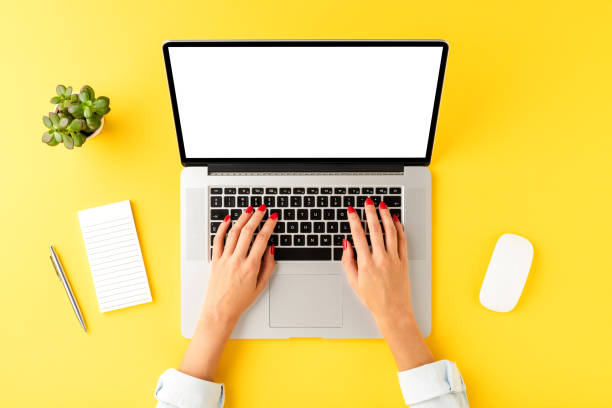 istock Businesswoman using laptop with empty screen. Business background with accessories. Top view 1268042689