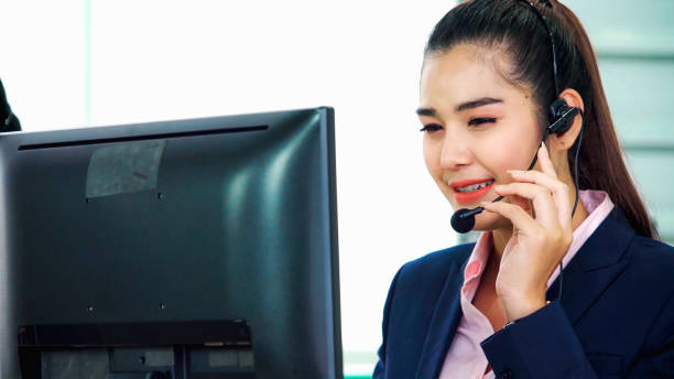 istock Business people wearing headset working in office 1268042805