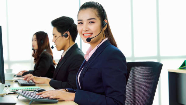 istock Business people wearing headset working in office 1268042841