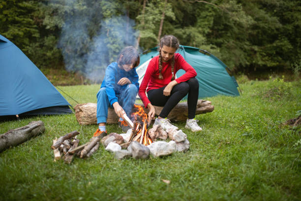 istock Boy and girl preparing campfire 1268042910