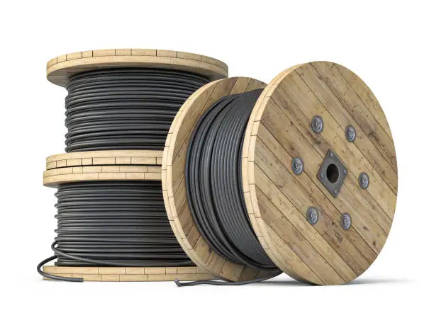 Photo of Wire electric cable on wooden coil or spool isolated on white background.
