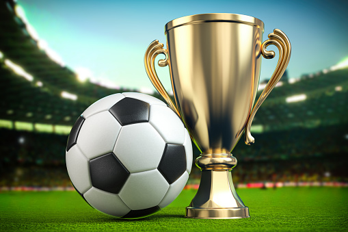 Football soccer ball and golden cup on the grass of football arena. 3d illustration