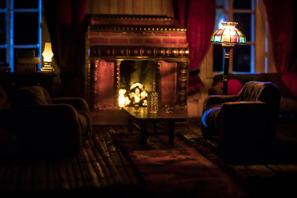 A realistic dollhouse living room with furniture and window at night. Artwork table decoration with handmade realistic dollhouse. A realistic dollhouse living room with furniture and window at night. Artwork table decoration with handmade realistic dollhouse. Selective focus. fireplace and armchair stock pictures, royalty-free photos & images