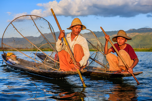 Fisherman posing on Inle Lake. Leg-rowing fishermen on Inle Lake are a major tourist destination in Myanmar (Burma).