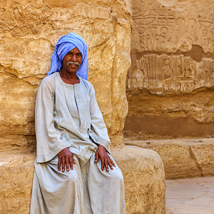 Giza, Cairo, Egypt. February 18, 2022. Men on camels at the Great Pyramid complex in Giza.