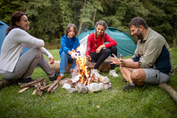 istock Family sitting around campfire 1268046707