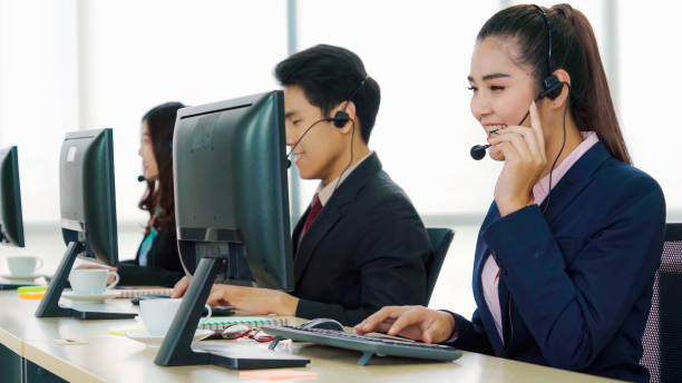 istock Business people wearing headset working in office 1268047762