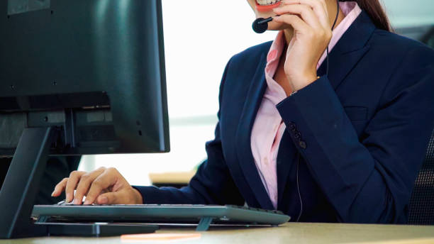 istock Business people wearing headset working in office 1268047966