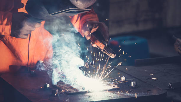 istock Metal welder working with arc welding machine 1268048019