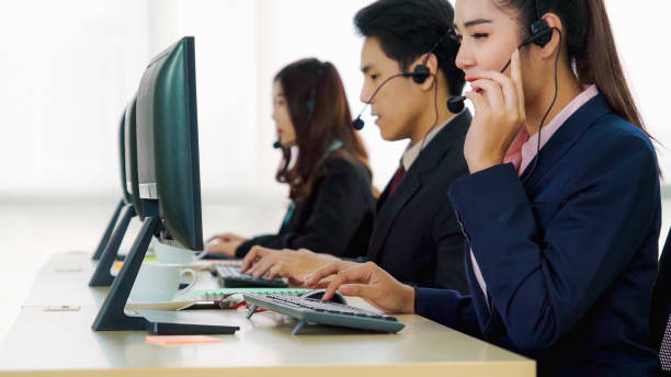 istock Business people wearing headset working in office 1268048053