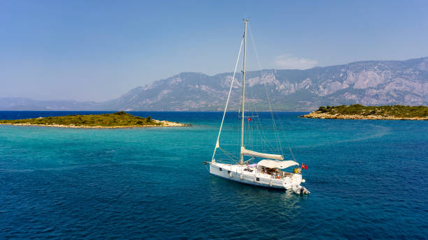 White yacht in the Aegean sea near the islands. White yacht in the Aegean sea near the islands. aegean sea stock pictures, royalty-free photos & images