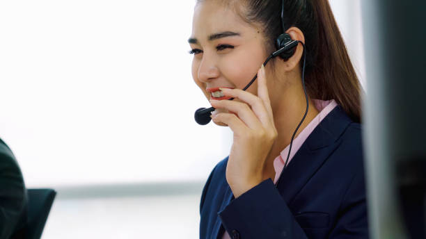 istock Business people wearing headset working in office 1268049355