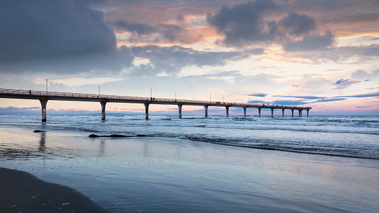 New Brighton Beach Pier Panorama in Sunset Twilight Light. XXXL Panorama Shot. With a 300m (980 feet) length into the south pacific ocean it's the longest pier of AustralAsia. New Brighton Beach, New Brighton, Christchurch, South Island, New Zealand, Oceania.