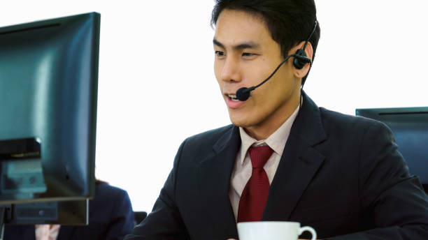 istock Business people wearing headset working in office 1268049957