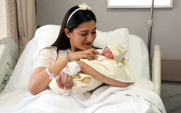 istock Newborn baby with mother 1268050048