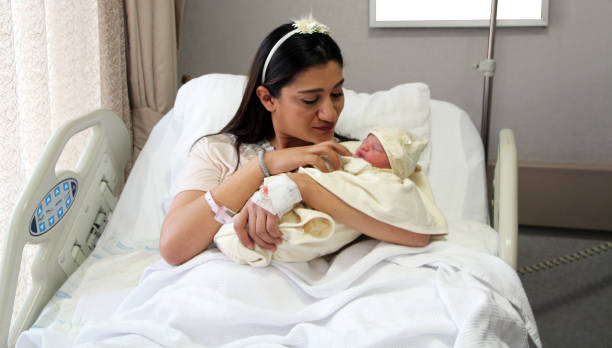istock Newborn baby with mother 1268050053