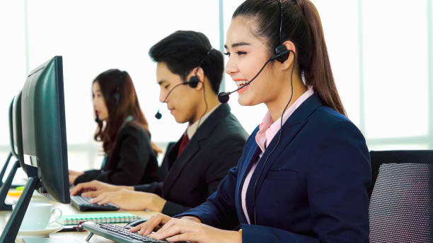 istock Business people wearing headset working in office 1268050072