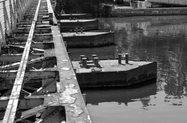 istock Old rusty metal pontoon bridge over the river. 1268050182