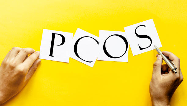 white paper with text PCOS - Polycystic ovary syndrome on a yellow background with man's hands white paper with text PCOS - Polycystic ovary syndrome on a yellow background with man's hands polycystic ovary syndrome photos stock pictures, royalty-free photos & images
