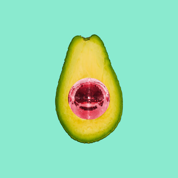 Avocado and disco ball on a colored background. Collage of modern art