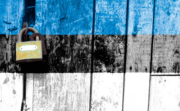 istock Estonian flag is on texture. Template. Coronavirus pandemic. Countries are closed. Locks. 1268054171