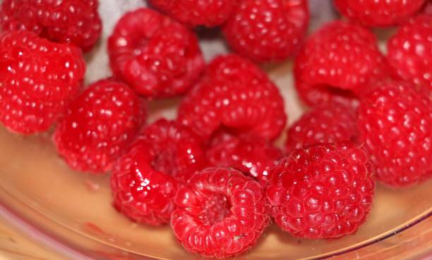 istock Closeup shot of a few fresh raspberries 1268056614
