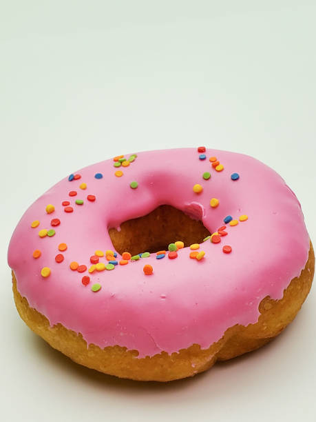 istock Delicious pink donut on a white background close-up 1268056720