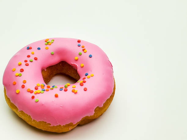 istock Delicious donut with pink frosting on white background 1268056727