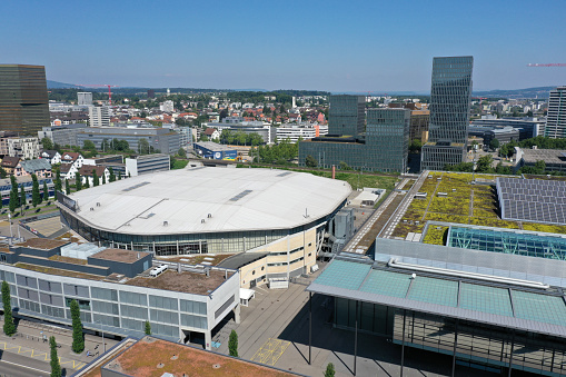 Oerlikon (Zurich) with several residential and some office buildings. In the foreground the Hallenstadion. The wide angle panoramic image was made during summer season in a beautiful sunny day.