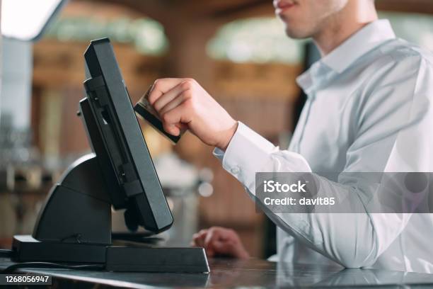 Small Business People And Service Concept Happy Man Or Waiter In Apron At Counter With Cashbox Working At Bar Or Coffee Shop Stock Photo - Download Image Now