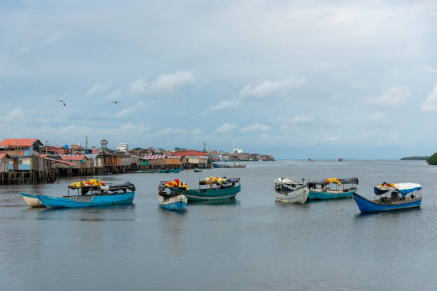 Fishing village with wooden house with stilts. Tumaco Colombia. Fisherman's boat anchored in calm waters where the houses are on wooden stilts. Tumaco Colombia. pacific coast stock pictures, royalty-free photos & images