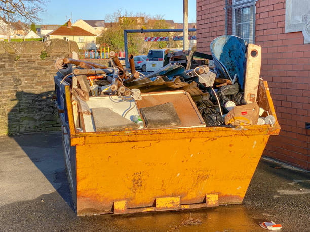 Industrial skip full of waste material during building improvement works Pontypridd, Wales - January 2020: Large industrial skip filled with waste after the refurbishment of a building. overflowing trash dumpster stock pictures, royalty-free photos & images