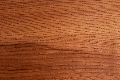 The structure of natural ash wood, tinted oak. Hardwood. Creative vintage background. Imitation of aging