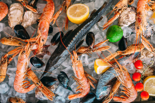 istock Seafood on ice. Crabs, sturgeon, shellfish, shrimp, Rapana, Dorado, on white ice. 1268060151