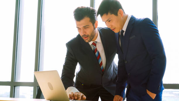 istock Two business people talk project strategy at office 1268061457
