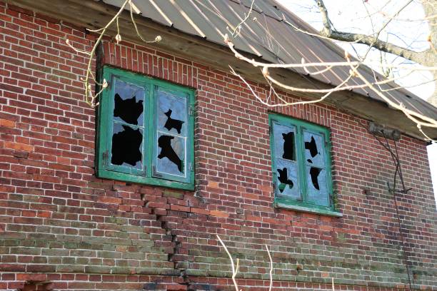 istock Low angle shot of an old abandoned building with broken windows 1268064124