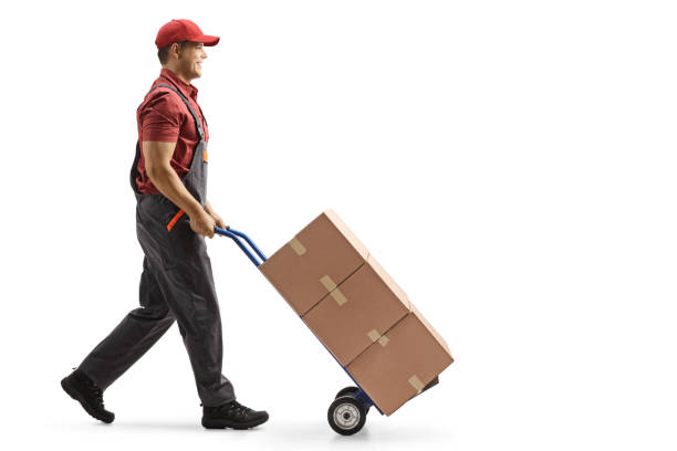 istock Male worker pushing boxes on a hand-truck 1268066634