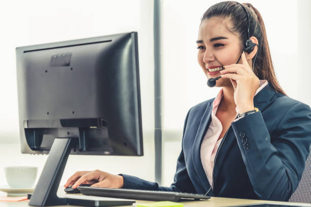 istock Business people wearing headset working in office 1268067785