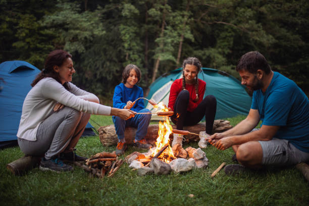 istock Family sitting around campfire 1268067876