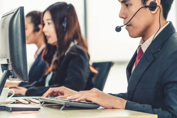 istock Business people wearing headset working in office 1268067966
