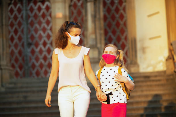istock modern mother and daughter going from school outside 1268068016