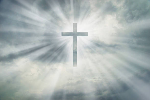 istock Christian cross appears bright on dramatic dark sky 1268069138