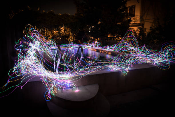 istock Pool and waterfall at night - vacation background. Colorful light decoration. Freezelight 1268069307