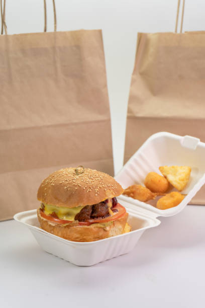 istock Paper bag and Burger in a box on an isolated white background 1268071155