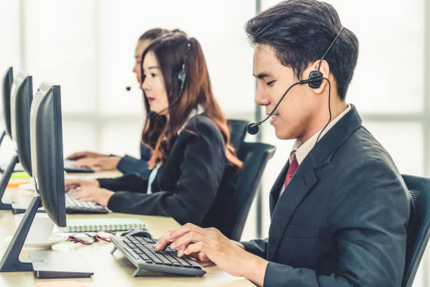 istock Business people wearing headset working in office 1268072036